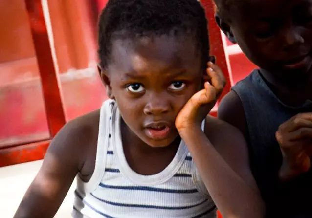 Boy sitting with hand propping up face